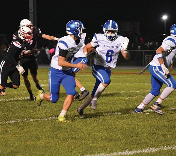 Mabel-Canton’s Breyvn Tollefsrud is in the open with a bit of a convoy from blockers Isaac Underbakke (left) and Darian Hershberger (right). The Cougars topped Wabasha-Kellogg 37-14 to clinch an 8-0 regular season. Photo by Heather Kleiboer: