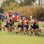 Cross country teams leave the line at the LARPH Meet held in Lewiston. Guys from the host team are notably middle left while those from LFC are middle right. Team Card-Tro-Cane (21) handily won their fifth run of the year, topping nearest foe Pine Island (80). Photo by Christine Vreeman