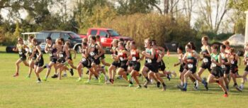 Cross country teams leave the line at the LARPH Meet held in Lewiston. Guys from the host team are notably middle left while those from LFC are middle right. Team Card-Tro-Cane (21) handily won their fifth run of the year, topping nearest foe Pine Island (80). Photo by Christine Vreeman