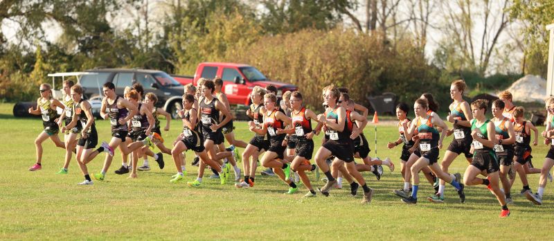 Cross country teams leave the line at the LARPH Meet held in Lewiston. Guys from the host team are notably middle left while those from LFC are middle right. Team Card-Tro-Cane (21) handily won their fifth run of the year, topping nearest foe Pine Island (80). Photo by Christine Vreeman