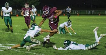 Chatfield’s D’Andre Williams tries to avoid Rushford-Peterson defenders Creighton Hoiness (#23) and Will LaFleur (#6). Williams and company did not avoid a win versus the Trojans, posting a 35-0 victory to improve to 5-0 on the year. Photo by Leif Erickson