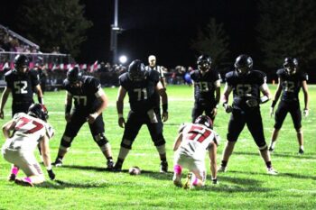 Fillmore Central lineman Ashton Newman (#52), Joseph Otto (#77), Ryan Schroeder (#71), and Brody Niemeyer (#62) line up to help Bridon Bahl (#13) and Kane Larson (#12) to score a short touchdown. FC had four drives of 10-plus plays in beating Lewiston-Altura 26-7, clinching the Falcons’ fourth straight sub-district title. Photo by Paul Trende