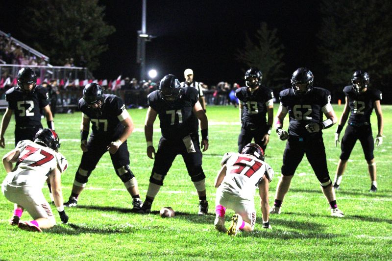 Fillmore Central lineman Ashton Newman (#52), Joseph Otto (#77), Ryan Schroeder (#71), and Brody Niemeyer (#62) line up to help Bridon Bahl (#13) and Kane Larson (#12) to score a short touchdown. FC had four drives of 10-plus plays in beating Lewiston-Altura 26-7, clinching the Falcons’ fourth straight sub-district title. Photo by Paul Trende