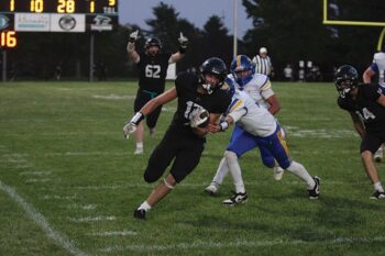 Brody Niemeyer’s expression in the background says it all as Fillmore Central’s Kane Larson treks up the sideline for 72-yard TD run to start FC’s scoring in a 53-0 win over Hayfield. The #4 in Class A Falcons moved to 5-0. Photo by Paul Trende