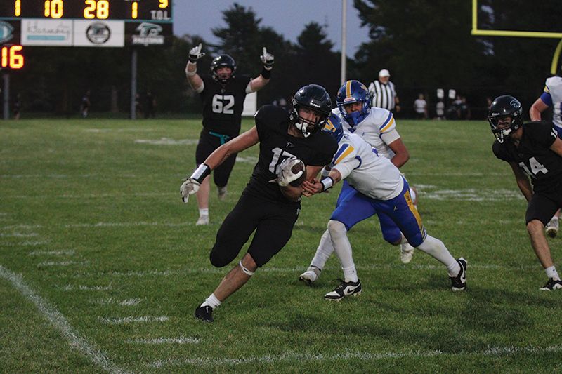 Brody Niemeyer’s expression in the background says it all as Fillmore Central’s Kane Larson treks up the sideline for 72-yard TD run to start FC’s scoring in a 53-0 win over Hayfield. The #4 in Class A Falcons moved to 5-0. Photo by Paul Trende