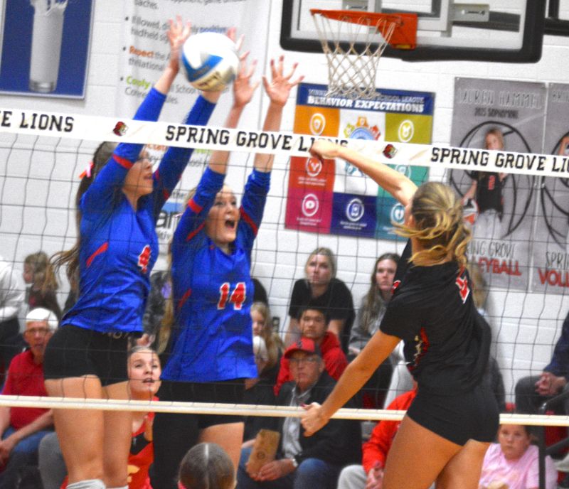 Mabel-Canton’s Ella Halverson and Braylee Stortz double block against the attack of Spring Grove’s Kylie Hammell in the teams’ second matchup of the year. M-C, the East division champ (13-0, 26-3), downed the Lions 3-1 after winning the earlier match 3-2. Photo by Lee Epps