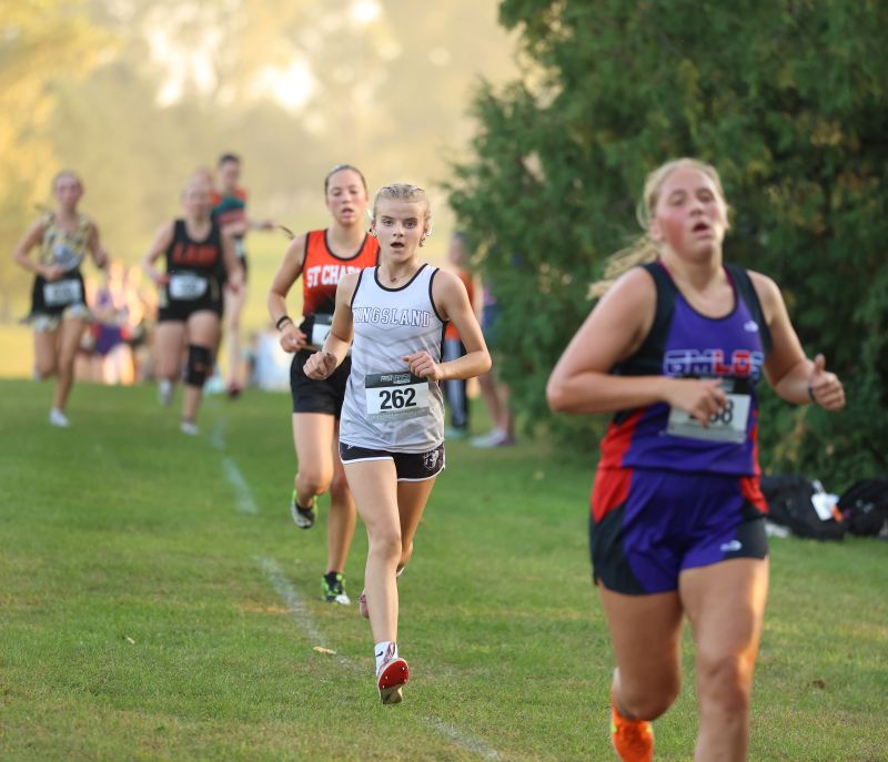 Kingsland’s Reeyin Lanning trails GMLOS’ Naomi Warmka at the LARPH cross country meet in Lewiston. Lanning took 12th to lead her team while Warmka took 13th to lead GMLOS. Photo by Christine Vreeman