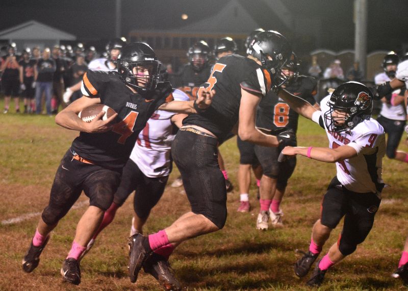 David Harvey (#5) blocks Spring Grove defender Ezra Konkel as Lanesboro quarterback Mason Gilbertson turns upfield on a 7-yard touchdown sweep to put the Burros ahead, 16-12. Spring Grove would come from behind three times before finally prevailing, 28-24. Photo by Lee Epps