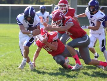 Houston’s Logan Kinstler (#97) and Atreyu Florin (#21) get after Grand Meadow quarterback Carter Glynn in the Hurricanes’ 50-6 win. The ‘Canes improved to 4-2 on the year. Photo by Paul Trende