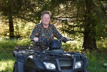 Bonnie Haugen drives her “work horse,” a necessity on a grazing farm – often more useful than a tractor. Photo by Charlene Corson Selbee