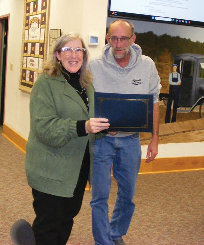 Mayor John McBroom presents Kay Wangen, finance and information systems director, with a certificate in recognition of her 25 years of service to Chatfield. Photo by Karen Reisner