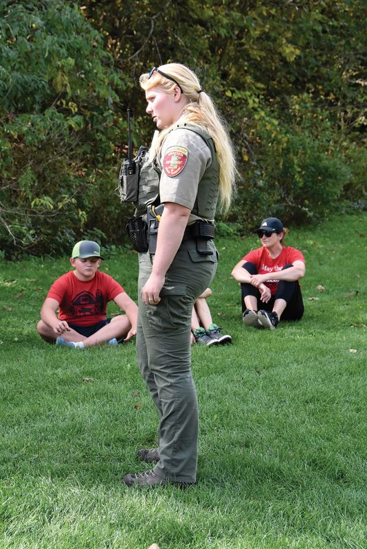Calli Weber, Conservation Officer Winona County DNR, answers students’ questions at the Environmental Day. In the background are Brenda O’Hara, sixth grade teacher at Houston Elementary School and two of her students. Photo by Charlene Corson Selbee