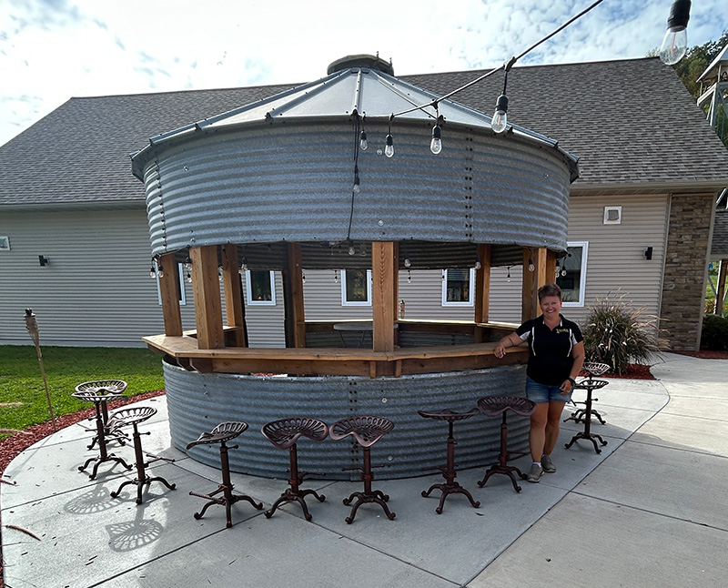 A new addition to Outback Ranch is the bar made from a repurposed grain bin with its antique tractor seat stools.Photo by Wanda Hanson