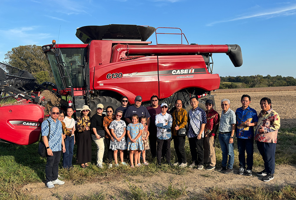 Some of the tour group posed with Groth and his family in front of his combine. Photo submitted