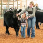 Lauren Chase of Mabel, Minn., assisted by Cora Mayer of Peterson, Minn. Photo by Dawn Hauge