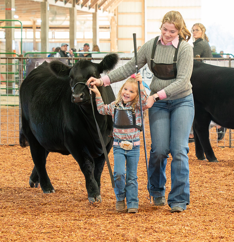 Lauren Chase of Mabel, Minn., assisted by Cora Mayer of Peterson, Minn. Photo by Dawn Hauge