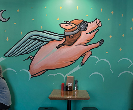 Murals can also be found inside businesses. This whimsical flying pig decorates Fat Pat’s in Spring Grove, thanks to the artistic talents of La Crosse art teacher Clint Grabhorn. Photo by Charlene Corson Selbee