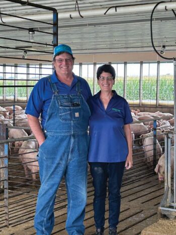 Greg and Deb Smith in one of the pig barns at their farm. Photo by Wanda Hanson