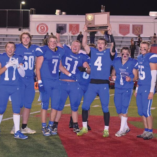 Mabel-Canton seniors (left to right) Mason Yoder, Michael Kime, Darian Hershberger, Milton Hutchinson, Isaac Underbakke, Kale Tollefsrud, and Nate Nordsving (plus an occluded Kenny Hutchinson) are all smiles after beating Spring Grove 16-0 in the 9-Man section 1 title game and earning M-C its first football state berth since 1981. Photo by Heather Kleiboer