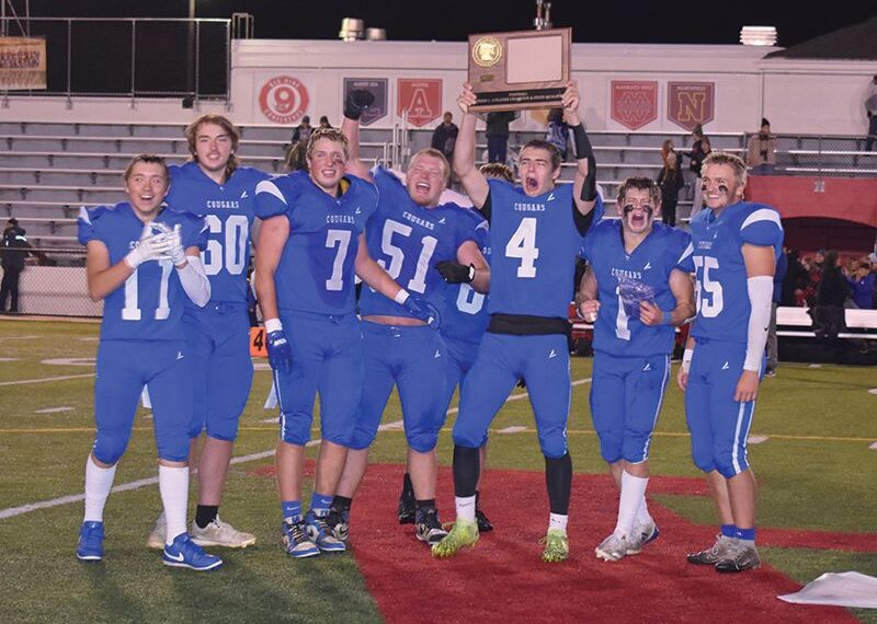 Mabel-Canton seniors (left to right) Mason Yoder, Michael Kime, Darian Hershberger, Milton Hutchinson, Isaac Underbakke, Kale Tollefsrud, and Nate Nordsving (plus an occluded Kenny Hutchinson) are all smiles after beating Spring Grove 16-0 in the 9-Man section 1 title game and earning M-C its first football state berth since 1981. Photo by Heather Kleiboer