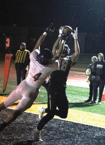 Caledonia’s Coby Hammell uses his 6’3” frame to catch the Warriors first touchdown in their 1AA title game win over Rochester-Lourdes, 19-3. Hammell had two TD receptions, a sack, a forced fumble, and a fumble recovery in the game. Photo by Paul Trende