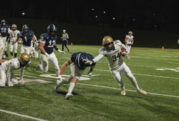 Caledonia’s Bo Knutson stiff-arms Jackson County Central’s Ben Gallagher on a run in the Warriors state quarterfinal loss. Knutson was busy with 42 rushing yards but 106 kick-off return yards. Photo by Isaac Blocker