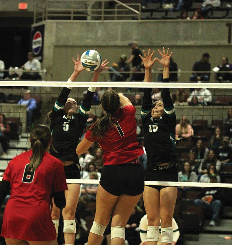 Fillmore Central’s Lauren Dahly (#5) appears to have the bead on a good block of Spring Grove’s Brinley Middendorf in the team’s 1A quarterfinal game. The Falcons won 3-1, but it was the only set they lost in four playoff games. Photo by Paul Trende
