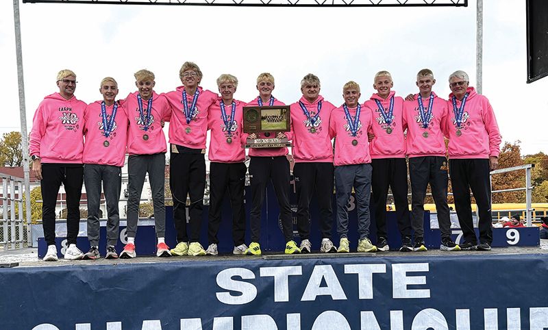 The 2025 state Class A cross country team from Lewiston-Altura/Rushford-Peterson/Houston. Coached by Sebastian Kingsbury (assistant, far left) and Matt Kingsbury (head, far right), team members (left to right) including alternates are Cole Timm, Damian Gossen, Aaron Ploetz, Hunter Rislov, Isaac Rasmussen, Trey Hegland, Grayson Speltz, Will Jewison, and Brennan Kunst. Photo by Ryan Eppen