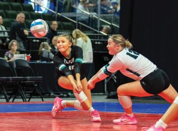 Fillmore Central defenders Norah Nagel (left) and Josie Corson (right) each go for an attack at the state Class A Tourney. The Falcons went 2-1 to take fifth place, as Corson had a team-best 65 digs over the three matches. Photo by Leif Erickson