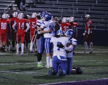 Somewhere between Mabel-Canton consoling players Isaac Underbakke and Kale Eiken (left), and Darian Hershberger and Milton Hutchinson (right), is where the Cougars’ season ended. Down 40-38 with the clock reading 0:00, an M-C two-point try failed, as Hillcrest Lutheran moved on to the 9-Man state semifinals. Photo by Paul Trende