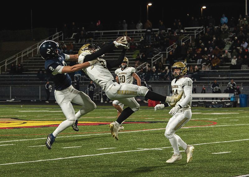 Caledonia senior Jacob Klug makes a nice interception on a pass intended for Jackson County Central’s Evan Bartholomaus in the teams’ AA state quarterfinal. The Warriors recorded three takeaways, but JCC rode the state’s top recruit, Minnesota signee, QB Roman Voss (256 yards rushing, 6 total TDs) to a 42-15 win. Photo Isaac Blocker