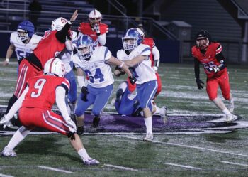 Mabel-Canton’s Kale Tollefsrud looks to run behind a block of senior teammate Kenny Hutchinson in the Cougars’ agonizing 40-38 loss to Hillcrest Lutheran in the state 9-Man quarterfinals. Photo by Paul Trende