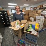 Rushford Food Shelf manager Andrea Andresen with a cart full of donations that just came in. Photo by Wanda Hanson