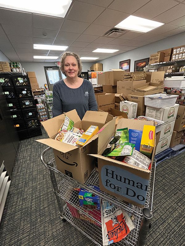 Rushford Food Shelf manager Andrea Andresen with a cart full of donations that just came in. Photo by Wanda Hanson