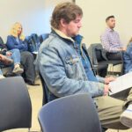 Staff, residents, and Caledonia City Clerk/Administrator Jake Dickson, front and center, attended the November 18 Houston County Commission Meeting. Photo by Charlene Corson Selbee
