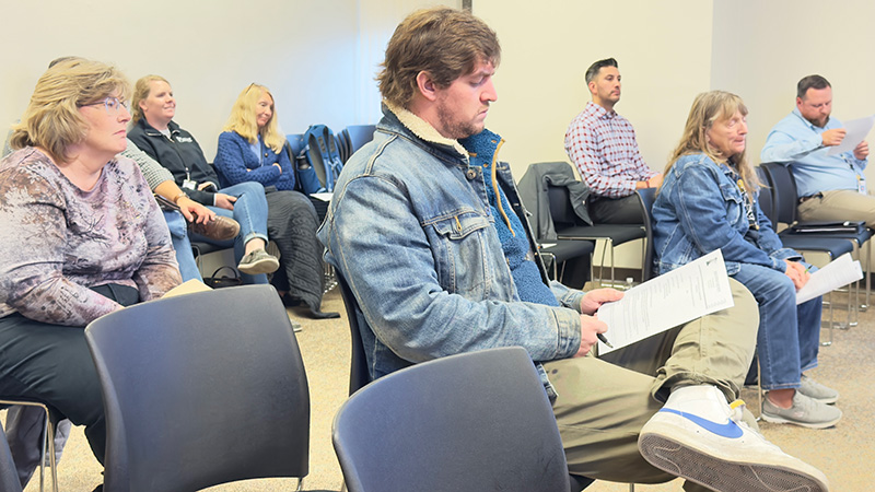 Staff, residents, and Caledonia City Clerk/Administrator Jake Dickson, front and center, attended the November 18 Houston County Commission Meeting. Photo by Charlene Corson Selbee