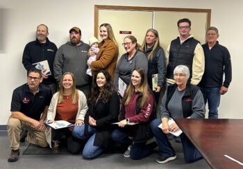 The ambulance crew, presenters, Lilah Christianson and her family pose together after the awards. Back row from left to right: Marty Momsen, dad Shawn Christiansen, Lilah Christiansen, mom Grace Christiansen, Mimi Carlson, Kendra VanGundy, Deven VanGundy and Mayor Scott Wallace. Front row from left to right: Chad Kuhlman from Southeast MN EMS, Anna Frauenkron, aunt April Carrier, Adrianna Hongerholt and ambulance director, Chris Cox. Photo by Wanda Hanson
