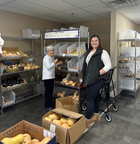 Marlene Peterson, left, a long-time volunteer of over 10 years, and case manager Morgan Steffens work to fill the shelves in Preston. The produce has been donated by area farmers and home gardeners. Photo by Kris Fultz