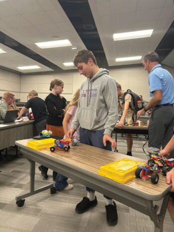 Michael Alexander explains how his slow motion vehicle works. The creation travels one foot for every 96 hours. Photo by Wanda Hanson