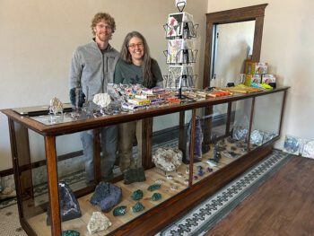 Aaron and Amy Bishop at the 12-foot display case filled with rocks of all kinds. Photo by Wanda Hanson