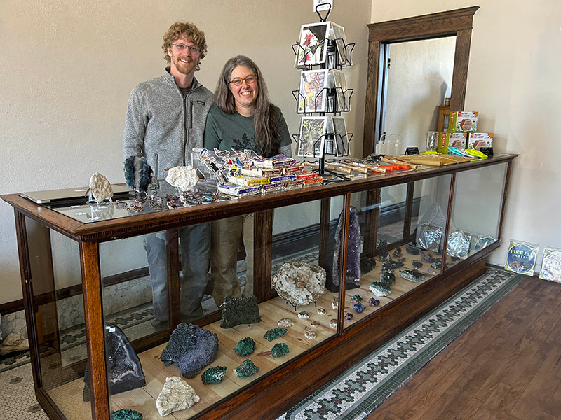 Aaron and Amy Bishop at the 12-foot display case filled with rocks of all kinds. Photo by Wanda Hanson