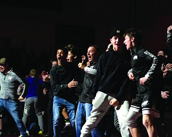 The Lewiston-Altura/Rushford-Peterson bench celebrates after Jaden Perez pinned Chatfield’s Jackson Bernard at heavyweight, enabling LARP to upset #2 in Class A Chatfield 39-36. Photo by Sarah Sexton