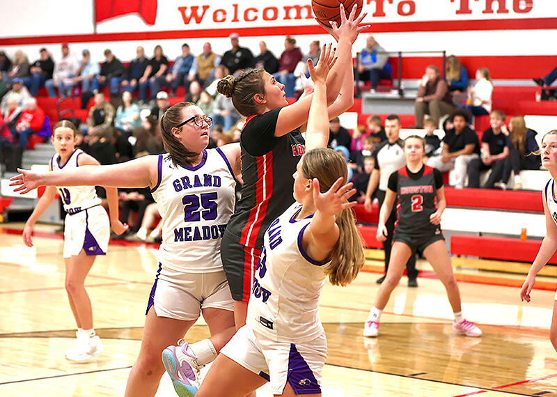 The girls basketball season got started including Grand Meadow playing at Houston. Above, Hurricane senior Jorja Meyer tries to score past Larks Cloey Breitbarth (#25) and Naomi Warmka (#23) in a Houston’s 68-42 win. Photo by Craig Johnson