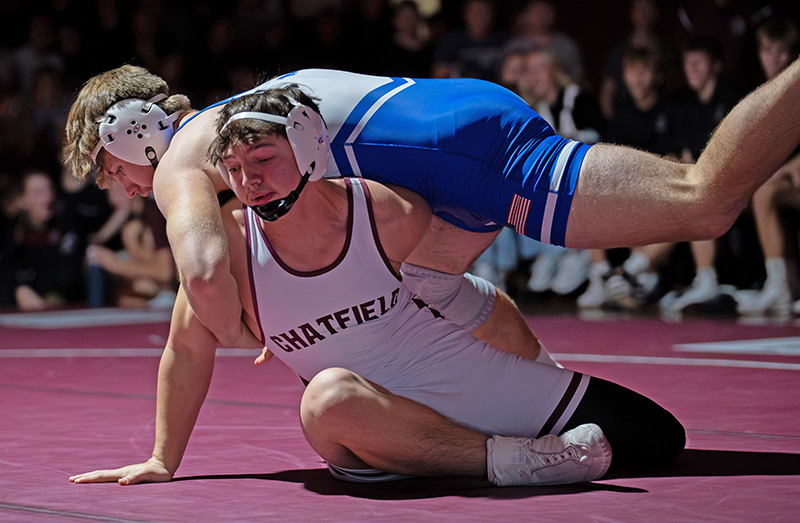 Chatfield’s Andrew Boelter battles Kasson-Mantorville’s Kasson Wynia at 215 pounds. In a key match in the dual, Boelter was tied 8-8 with the 7th-ranked Wynia in the third period, but made a mistake and fell by fall, part of the Komets 29-26 win. Photo by Leif Erickson