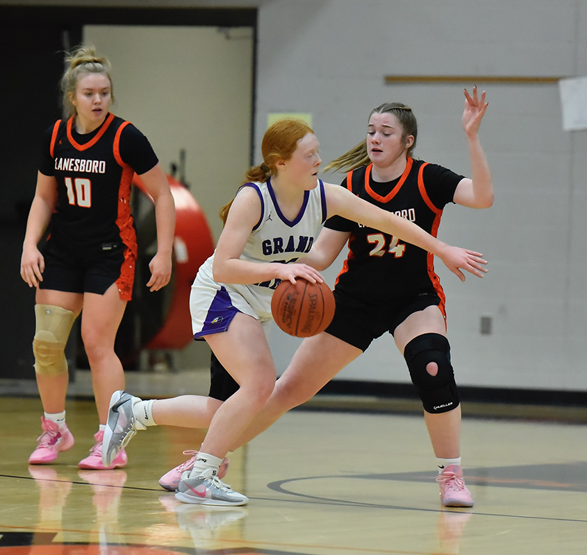 Lanesboro’s Cora Mayer defends Grand Meadow’s Gracie Foster off the dribble in the Burros’ 58-52 SEC win over the Larks. Team Lanes (4-1, 5-3), Spring Grove (5-1, 7-2) and Southland (4-1, 5-1) are the top three teams atop the SEC standings. Photo by Ron Mayer