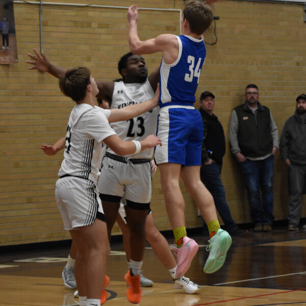 Mabel-Canton’s Kale Eiken looks to release a shot in the lane over primary Kingsland defender KD Reiland. The Cougars beat Faribault B.A. 70-60, the Knights 60-27, and Postville 77-56 to post a 3-0 week and improve to 4-1 on the season. Photo by Heather Kleiboer