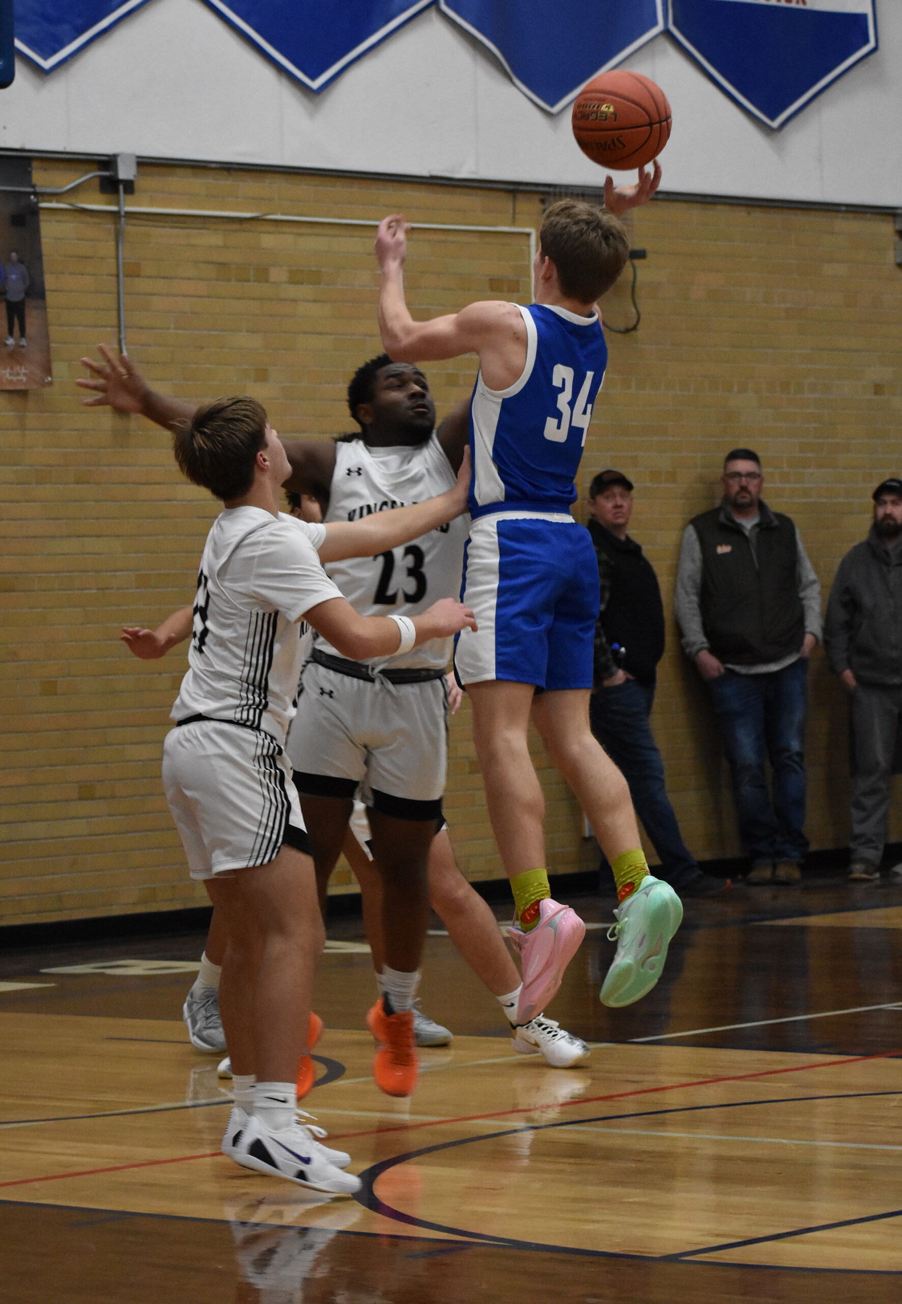 Mabel-Canton’s Kale Eiken looks to release a shot in the lane over primary Kingsland defender KD Reiland. The Cougars beat Faribault B.A. 70-60, the Knights 60-27, and Postville 77-56 to post a 3-0 week and improve to 4-1 on the season. Photo by Heather Kleiboer
