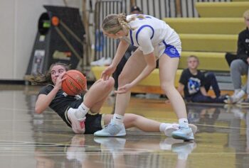 After digging out a steal, Caledonia’s Ashlyn Reinhart will toss ahead to Aubrie Klug for the assisted layup. The Warriors hammered Cotter/Hope Lutheran 62-26 in their home and TRC opener. Photo by Paul Trende