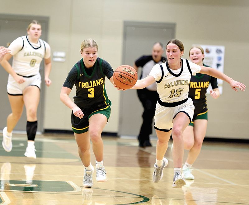 Rushford-Peterson’s Emily Helgemoe and Caledonia’s Nicole Banse vie for the ball in the teams’ TRC matchup. The Warriors won the contest 62-41 while also taking down #8 in AAA Byron 74-67. Photo by Craig Johnson
