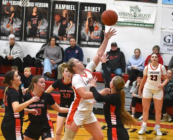 Lanesboro point guard Jensyn Storhoff drives, surrounded by four Spring Grove/Mabel-Canton defenders (from left), Carlie Halverson, Kylie Hammel, Lauren Hammel and Kinley Soiney. The Burros avenged a 2025 section play off loss with a key SEC victory, 61-52. Photo by Lee Epps